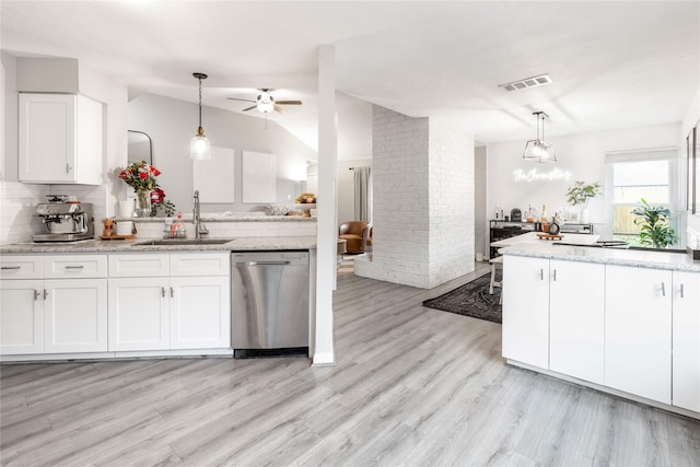 kitchen with visible vents, a sink, stainless steel dishwasher, white cabinetry, and lofted ceiling