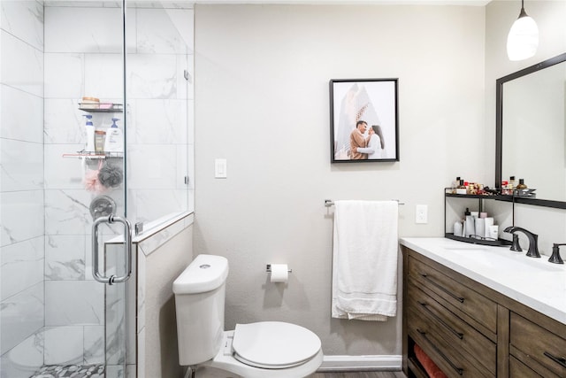 full bathroom with vanity, toilet, and a shower stall