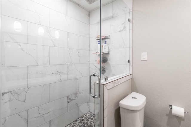 full bathroom featuring toilet and a stall shower