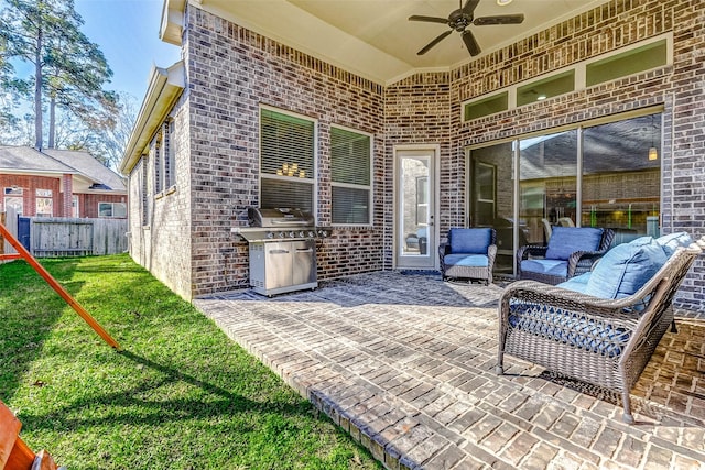 view of patio / terrace with ceiling fan and fence