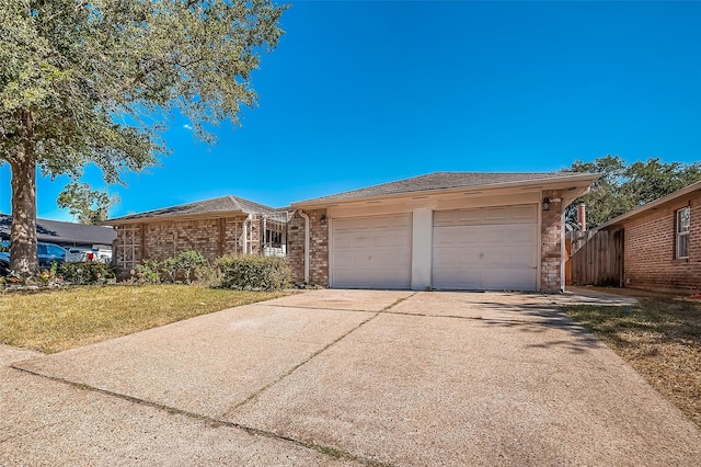 view of front of home with brick siding, driveway, and an attached garage