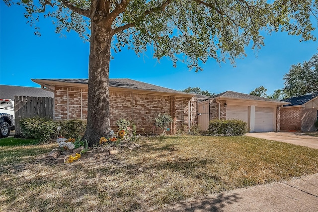 single story home with brick siding, a front lawn, fence, a garage, and driveway