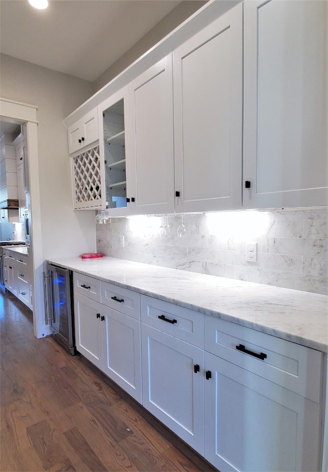 kitchen with glass insert cabinets, white cabinetry, wine cooler, decorative backsplash, and dark wood-style flooring