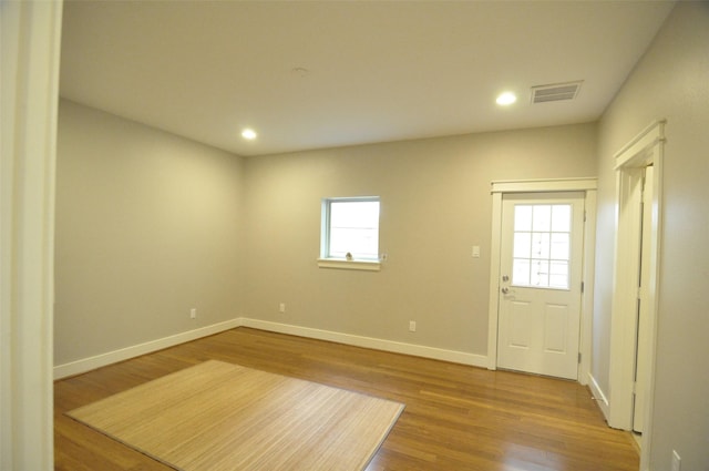 interior space with recessed lighting, wood finished floors, visible vents, and baseboards