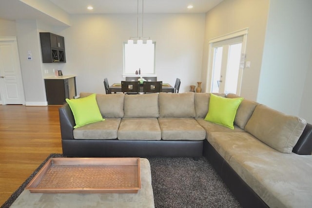 living area featuring wood finished floors, recessed lighting, and baseboards