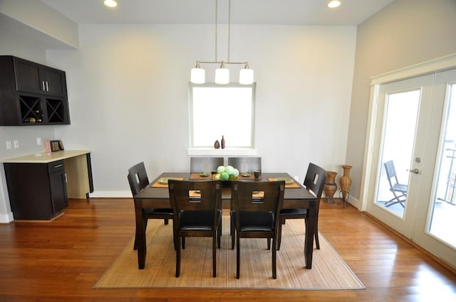 dining area featuring wood finished floors, recessed lighting, french doors, and baseboards