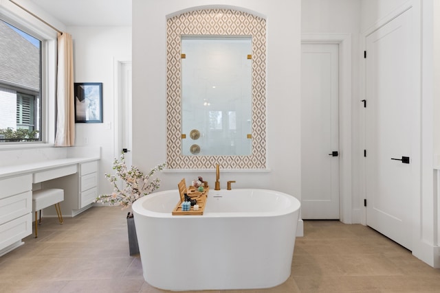 bathroom featuring tile patterned flooring, tiled shower, and a freestanding bath