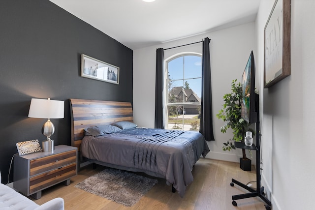 bedroom with wood finished floors and baseboards