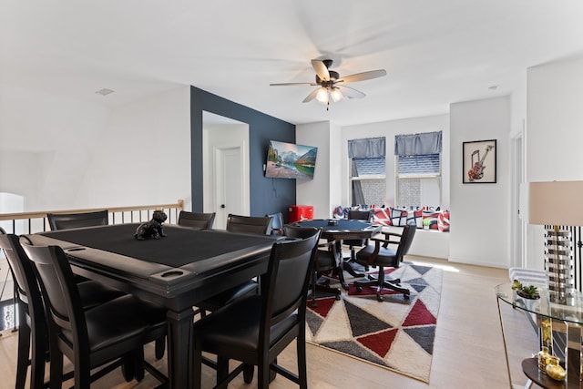 dining area featuring light wood-style flooring and a ceiling fan