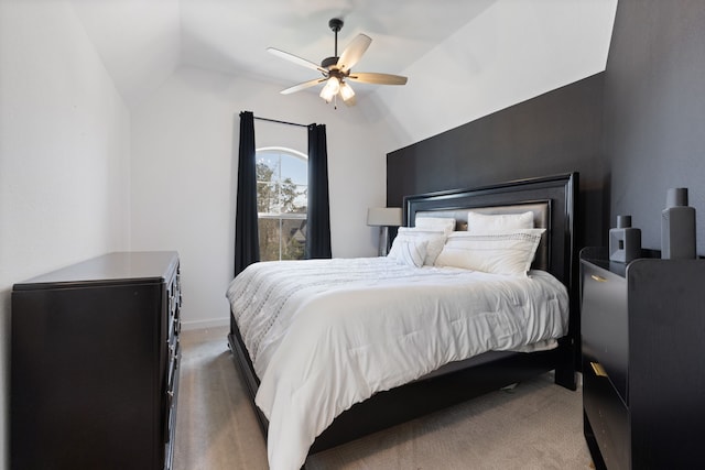 carpeted bedroom featuring lofted ceiling and ceiling fan