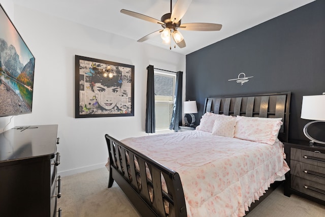 carpeted bedroom featuring a ceiling fan and baseboards