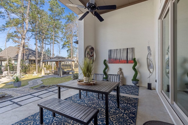 view of patio with a gazebo, a ceiling fan, and fence