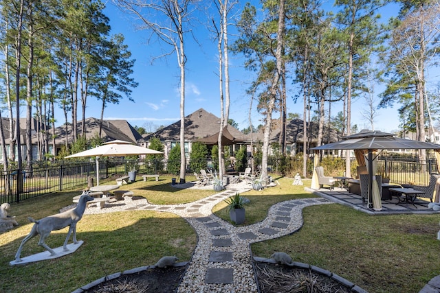 view of home's community with a patio area, fence, and a lawn