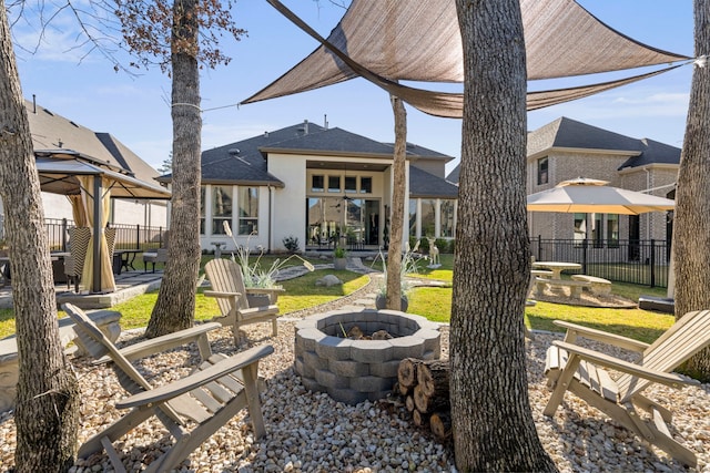 view of yard with a gazebo, a patio area, a fire pit, and fence