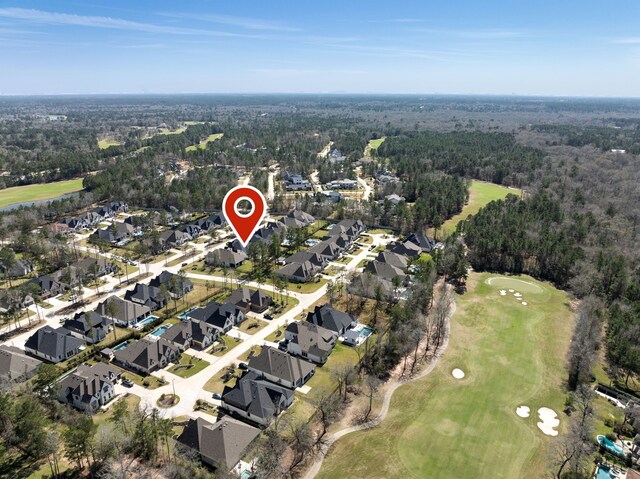 birds eye view of property with a residential view, a forest view, and view of golf course