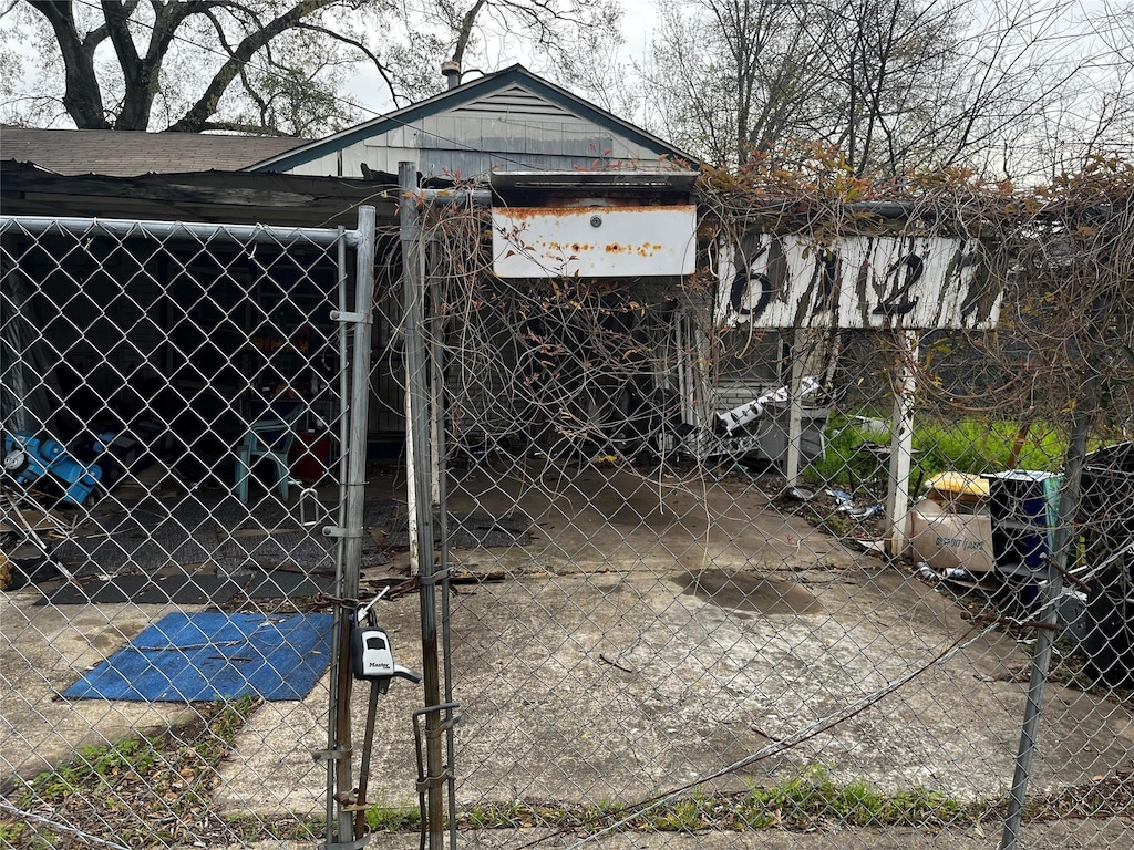 view of outbuilding featuring a gate and fence