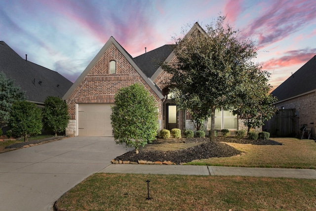 view of front facade with an attached garage, a shingled roof, concrete driveway, a front lawn, and brick siding