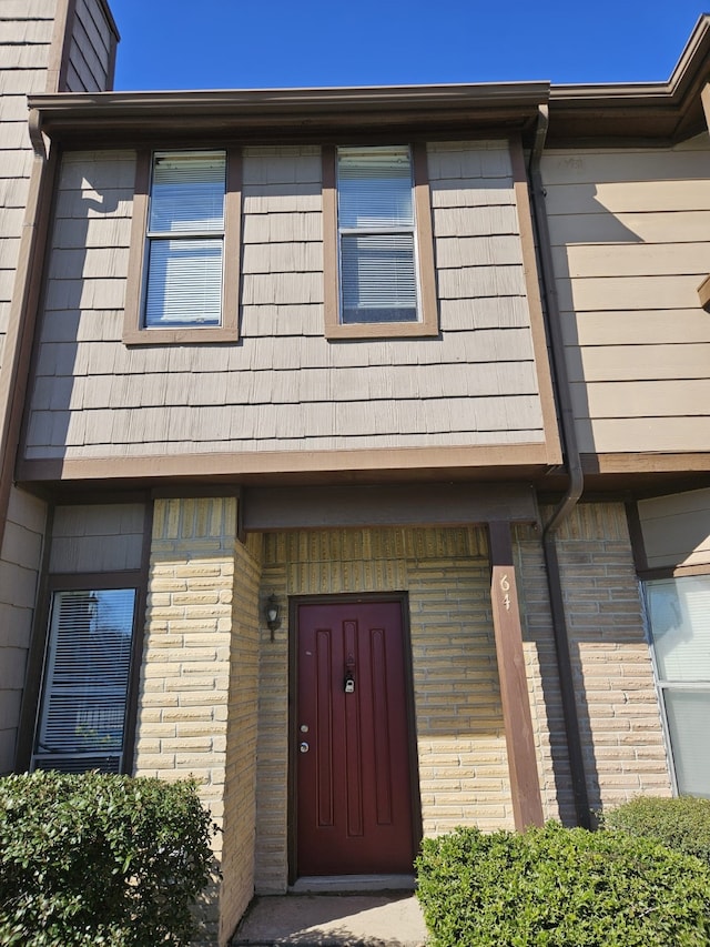 entrance to property with brick siding