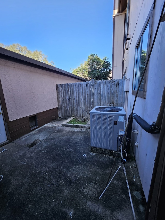 view of yard with a patio area, cooling unit, and fence