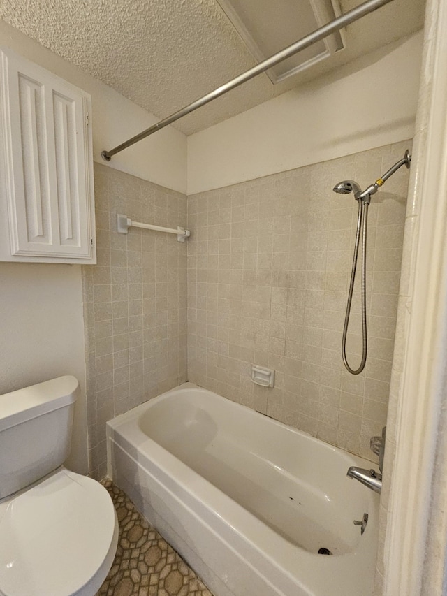 bathroom with  shower combination, toilet, and a textured ceiling