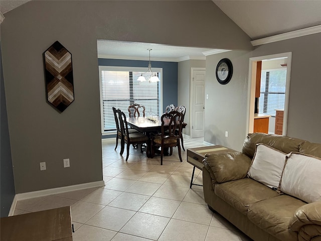 living room featuring light tile patterned flooring, a chandelier, lofted ceiling, and ornamental molding