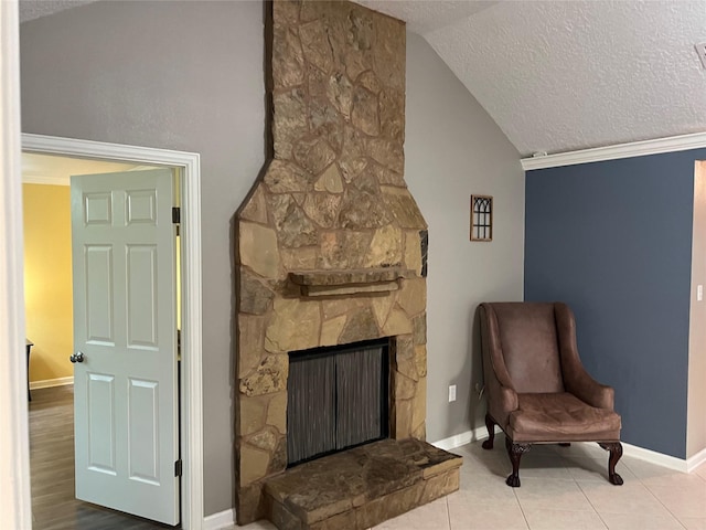 sitting room featuring vaulted ceiling, a fireplace, baseboards, and a textured ceiling