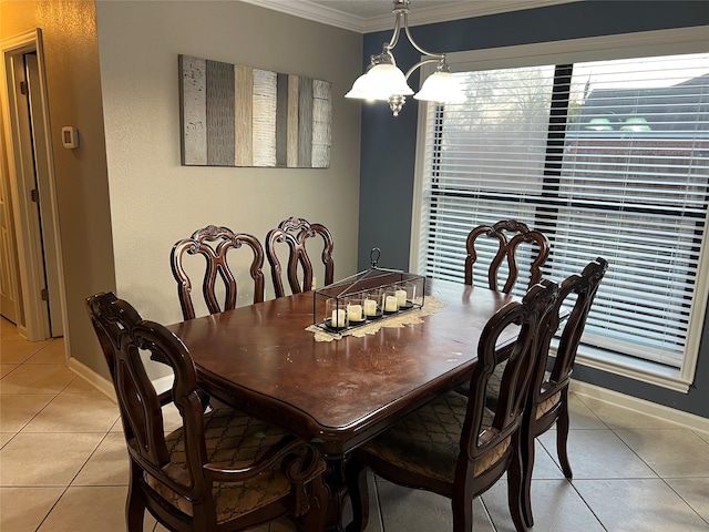 dining area with crown molding, light tile patterned floors, baseboards, and a chandelier