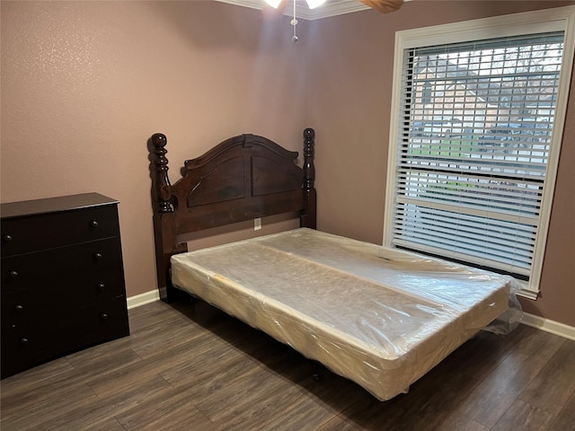 bedroom with baseboards and dark wood-type flooring