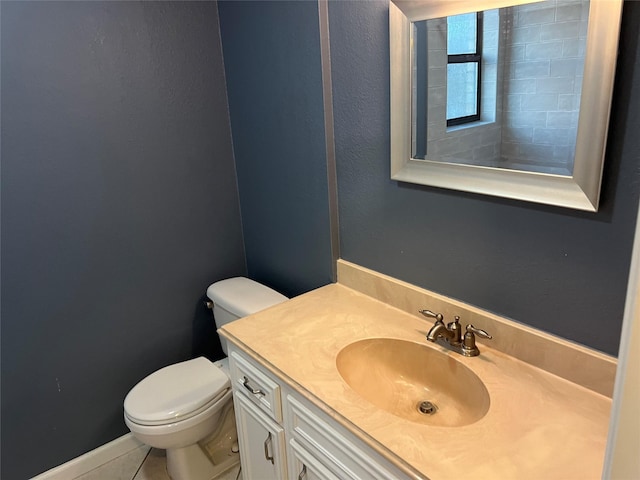 half bath with toilet, vanity, and tile patterned flooring