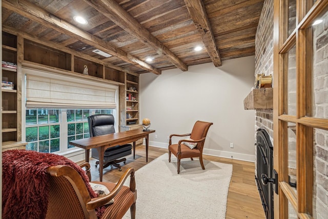 office featuring light wood-style flooring, baseboards, beamed ceiling, and wooden ceiling