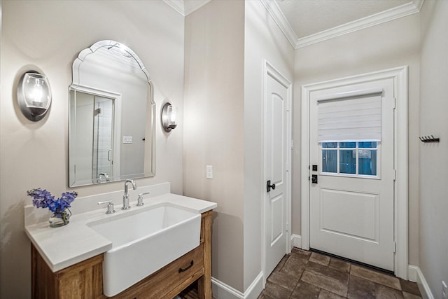 bathroom with vanity, baseboards, and ornamental molding