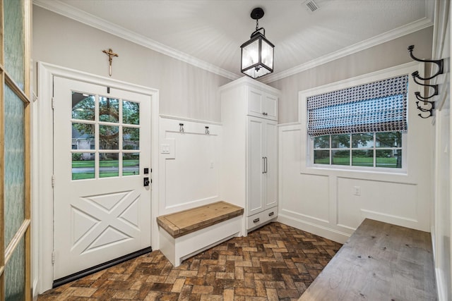 mudroom featuring brick floor, visible vents, and ornamental molding