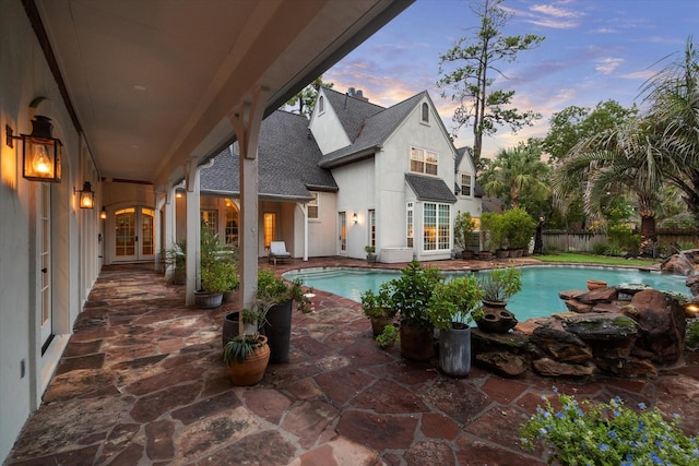 view of swimming pool featuring a patio, a fenced in pool, french doors, and fence