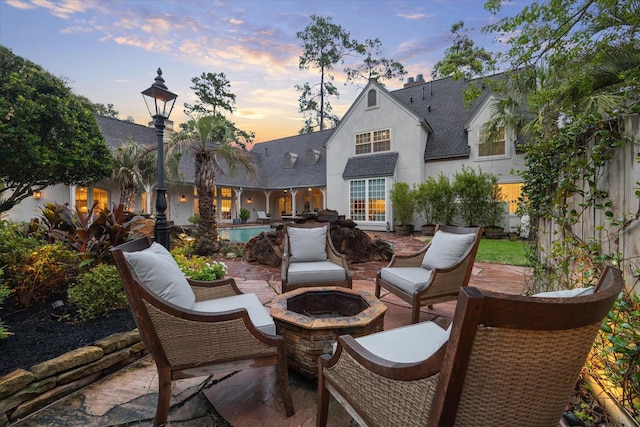 view of patio / terrace with an outdoor pool and an outdoor fire pit