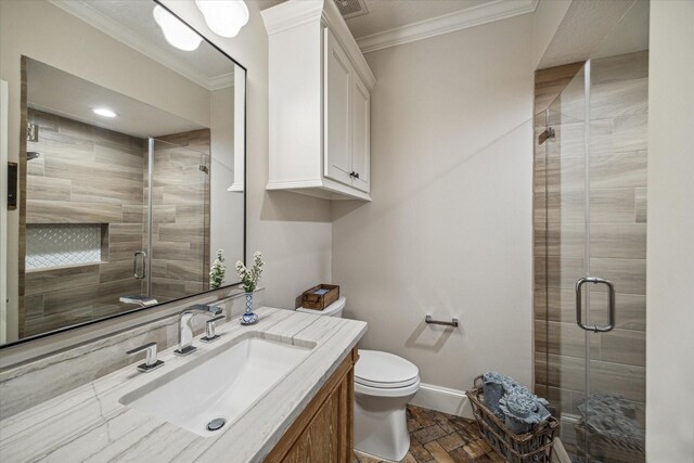 bathroom featuring vanity, baseboards, a stall shower, ornamental molding, and toilet