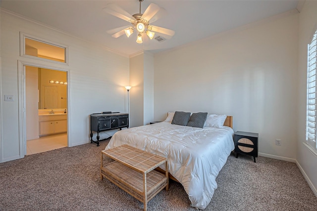 carpeted bedroom with a sink, crown molding, baseboards, and ceiling fan