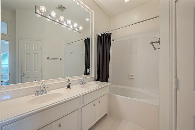 bathroom with tile patterned floors, visible vents, shower / bath combo with shower curtain, and a sink