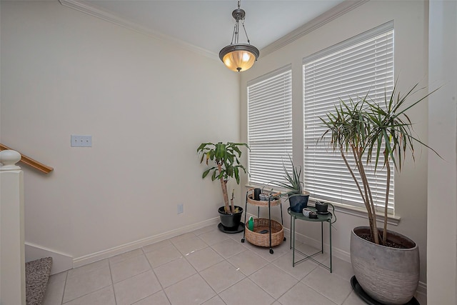 sitting room with baseboards, light tile patterned flooring, and crown molding