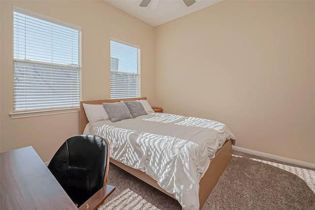 carpeted bedroom featuring baseboards and ceiling fan