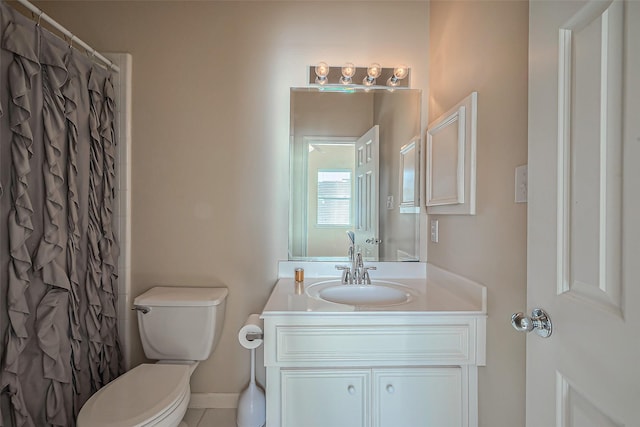 bathroom with toilet, vanity, and a shower with curtain