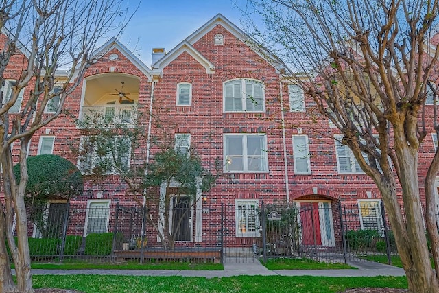 view of front facade with brick siding and ceiling fan