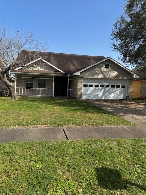 ranch-style home featuring covered porch, an attached garage, concrete driveway, and a front lawn