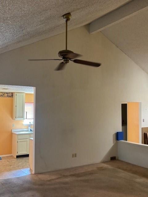 spare room with beam ceiling, a textured ceiling, ceiling fan, and high vaulted ceiling