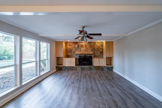 unfurnished living room featuring a textured ceiling, wood finished floors, a fireplace, crown molding, and baseboards