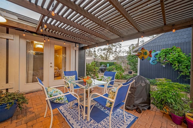 view of patio with outdoor dining area, a pergola, and fence