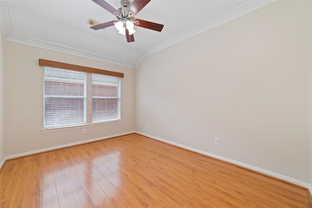 spare room with baseboards, ornamental molding, a ceiling fan, and light wood finished floors