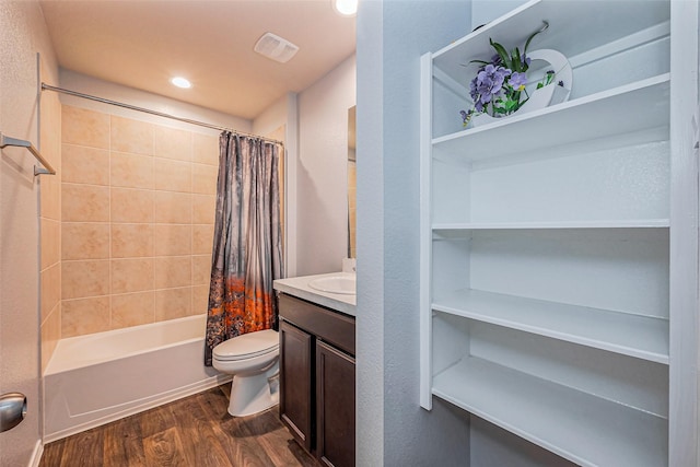 full bathroom featuring vanity, wood finished floors, visible vents, shower / bath combination with curtain, and toilet