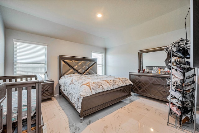 bedroom with recessed lighting and marble finish floor