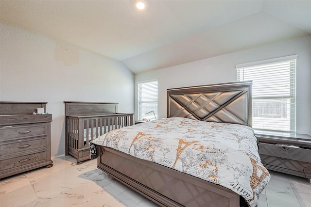 bedroom featuring marble finish floor and vaulted ceiling