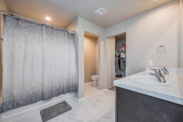 bathroom featuring visible vents, baseboards, toilet, marble finish floor, and vanity